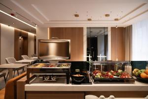 a kitchen with a stove and some food on a counter at Garni Hotel Galeria in Banja Luka