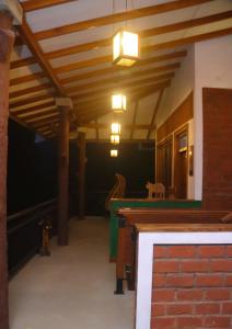 a living room with a wooden ceiling and a table at Rawana Mount View - Ella in Bandarawela