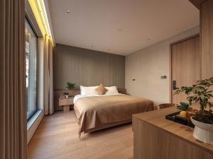 Krevet ili kreveti u jedinici u okviru objekta Qingdao Wushe Yujianshanju Tangchi Seaview Hotel