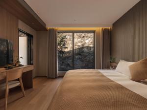 Krevet ili kreveti u jedinici u okviru objekta Qingdao Wushe Yujianshanju Tangchi Seaview Hotel