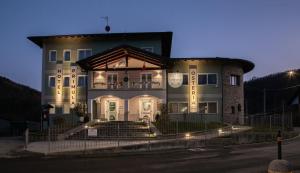 a large building with stairs in front of it at night at La Primula in Borgo San Dalmazzo