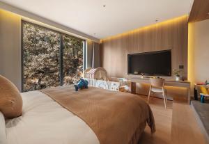 Krevet ili kreveti u jedinici u okviru objekta Qingdao Wushe Yujianshanju Tangchi Seaview Hotel