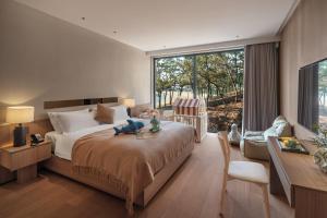 Krevet ili kreveti u jedinici u okviru objekta Qingdao Wushe Yujianshanju Tangchi Seaview Hotel