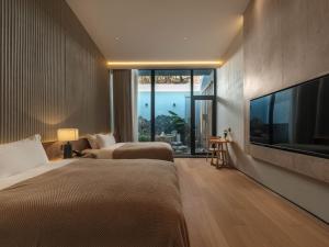 Krevet ili kreveti u jedinici u okviru objekta Qingdao Wushe Yujianshanju Tangchi Seaview Hotel