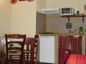 a kitchen with a table and a counter top at La Casa Delle Cascate in Saturnia