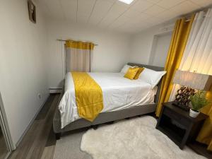 a bedroom with a bed with a yellow blanket on it at Fairbanks Rafiki Unit 2 in Fairbanks