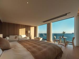 Krevet ili kreveti u jedinici u okviru objekta Qingdao Wushe Yujianshanju Tangchi Seaview Hotel