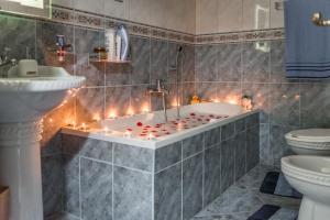 a bathroom with a tub with candles in it at Aria Apartment in Durrës +45 photos
