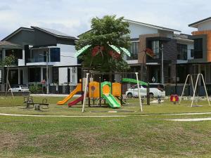 a park with a playground with a slide and swings at Botani Double-Storey Haven 5B4B by verve 19pax in Ipoh