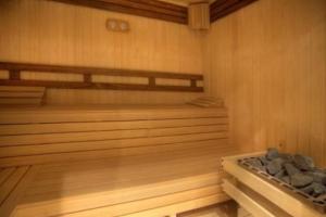 a sauna with wooden walls and a wooden floor at Alpine Charm Borovets Apart in Borovets