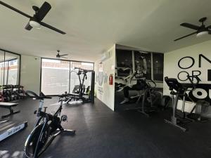 a gym with a woman working out in a gym at Departamento en Puerto Vallarta in Puerto Vallarta