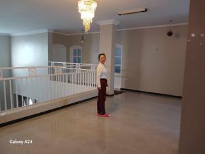 a woman standing in the middle of a room at Valencia Villa & Rooms in Luxor