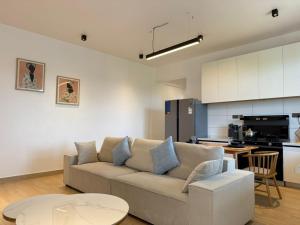 a living room with a couch and a kitchen at Masaki Haven in Dar es Salaam