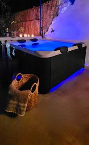 a bath tub with blue lights in a room at Aegean Serenity - Sea View Retreat in Archangelos +50 photos
