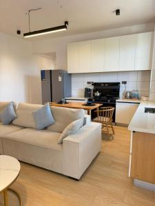 a living room with a couch and a kitchen at Masaki Haven in Dar es Salaam +50 photos