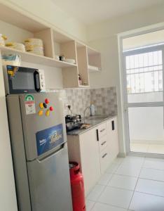 a kitchen with a stainless steel refrigerator and a window at Habibi Homes in Mombasa