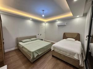 a bedroom with two beds in a room at Luxury Private Pool Villa C-Two in Aksu +34 photos