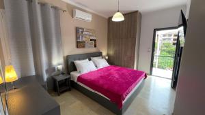 a bedroom with a bed with a pink blanket at Katerina s House 1 in Nydri