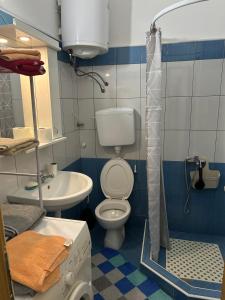 a bathroom with a toilet and a sink at Apartment S in Odžaci