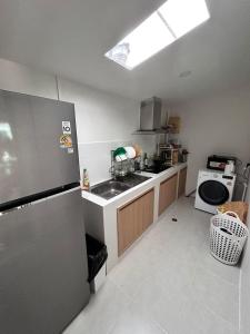 a small kitchen with a sink and a refrigerator at Phuket House House with excellent location and excellent views Sleeping area Отличный Дом, Комната со всеми удобствами in Phuket Town