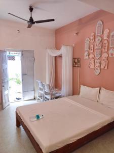 a bedroom with a large white bed in a room at Vanam Soulful Stays in Pondicherry +95 photos