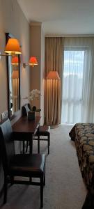 a hotel room with a desk and a bed and a mirror at Barcelo Royal Beach in Sunny Beach