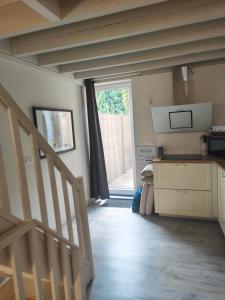 a room with a staircase and a room with a window at Le cocon de Veyre in Martres-de-Veyre