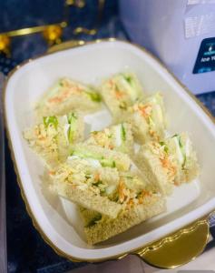 a white plate of sandwiches on a table at Udokanson Hotel And Suites in Agbor
