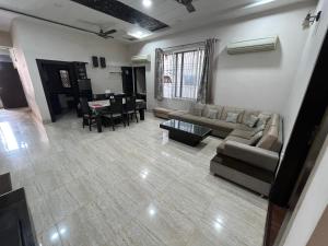 a living room with a couch and a dining room at Rukmani Kunj in Varanasi +34 photos