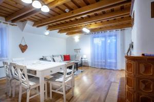 a living room with a white table and chairs at Apartmanica Fairy Tale, JASNÁ - SKI TÁLE- MÝTO POD ĎUMBIEROM, 3 apartments in 1 house, fireplace, free parking in Horná Lehota +35 photos