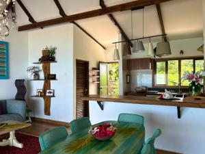 a kitchen and dining room with a table and chairs at Village des Iles in Praslin