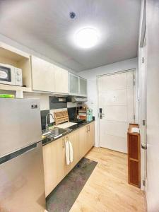 a kitchen with a sink and a refrigerator at Casa de Amor in Kaybagal