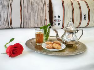 a tray with a tea kettle and a plate of food at Charming house with pool in Zagora in Zagora