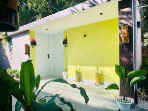 a yellow house with plants in front of it at Sun Oasis Resort in Cox's Bazar