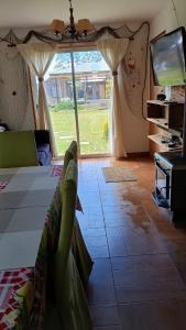 a bedroom with a bed and a tv and a window at Costa Monkul - Carahue y Puerto Saavedra in Nahuentúe