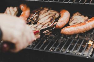 a group of sausages and meat on a grill at Hakone Villa in Hakone