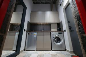 a kitchen with a washer and a washing machine at Tango Guest House in Gyumri