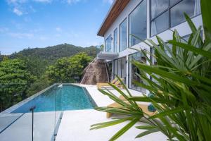 a view of a house with a swimming pool at Inn Harmony Villa Seaview in Ko Phangan