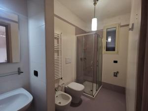 a bathroom with a shower and a toilet and a sink at Residence Tresor in Gallipoli +42 photos