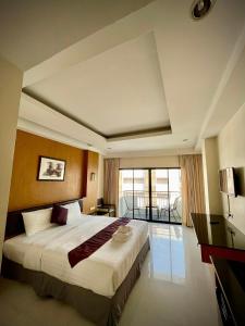 a bedroom with a large bed and a balcony at My PLACE HUA-HIN HOTEL in Hua Hin