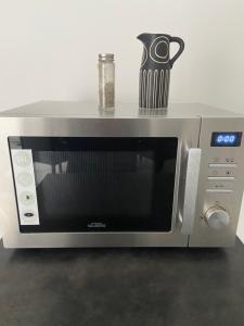 a microwave oven with a pot on top of it at Maison avec jardin proche Paris et Disney in Pontault-Combault