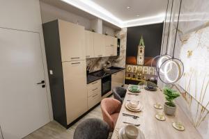 a kitchen with a table and chairs in a room at Old town in Varaždin
