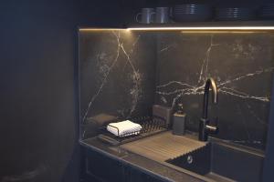 a kitchen counter with a sink and aaucet at Valletta San Mark in Valletta +20 photos