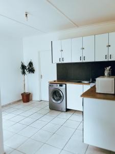 a kitchen with a washer and a washing machine at City Central Self-catering in Windhoek +9 photos