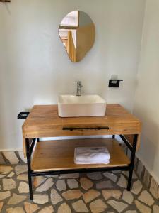 a bathroom with a sink and a mirror at Acacia Wilderness Mweya in Kasese