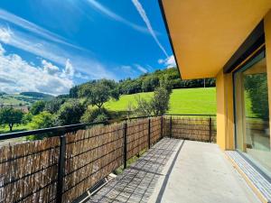 a balcony with a view of the countryside at Slnečná vila pod lesom in Horný Vadičov