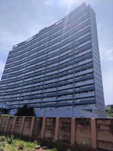 a tall office building with a fence in front of it at Stella Maris Deluxe in Amanzimtoti