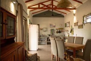 a kitchen with a table and a white refrigerator at The Stables in Khanzi