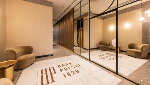 a lobby with chairs and a sign that reads bank rolls at Flatbook - City Center Apartment Bank Polsk in Gdynia +24 photos