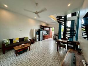 a living room with a couch and a table at Work remotely from our Duplex Loft, King Bed, Pool & Garden, Soundbar in Siem Reap